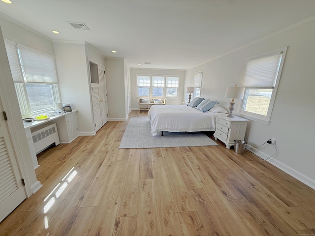 bedroom with light wood-style flooring, crown molding, radiator, and visible vents