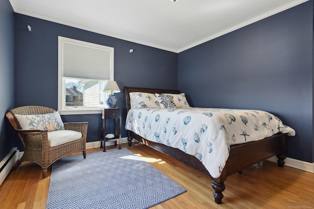 bedroom featuring baseboards, a baseboard radiator, ornamental molding, and wood finished floors