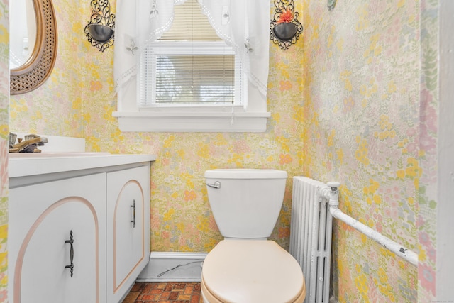 90 Culloden Rd, Stamford, CT 06902 - bathroom featuring toilet, brick floor, radiator, vanity, and wallpapered walls