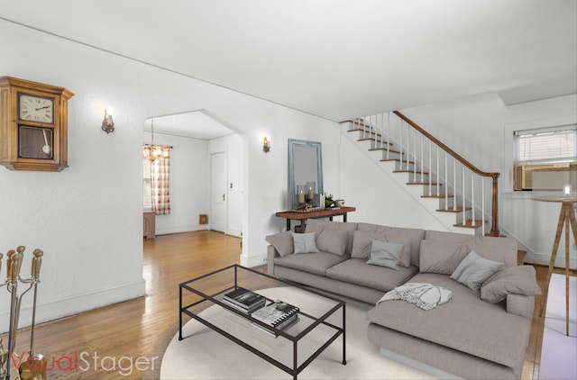 90 Culloden Rd, Stamford, CT 06902 - living area featuring cooling unit, stairway, a chandelier, and wood finished floors