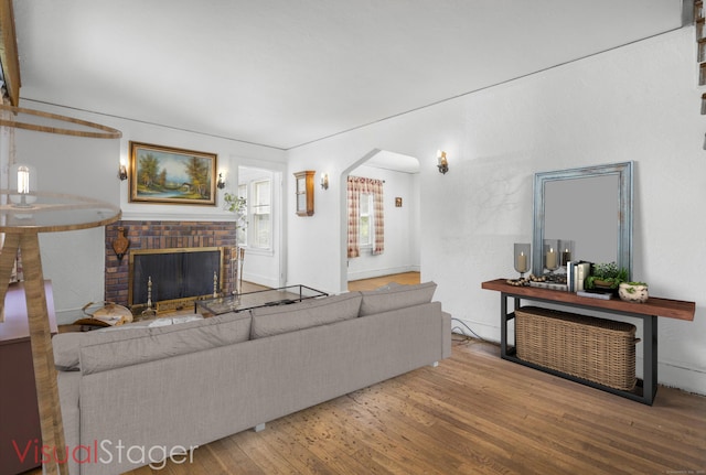 90 Culloden Rd, Stamford, CT 06902 - living area with a brick fireplace and wood finished floors