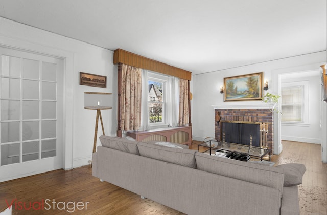 90 Culloden Rd, Stamford, CT 06902 - living room with wood finished floors, baseboards, and a brick fireplace