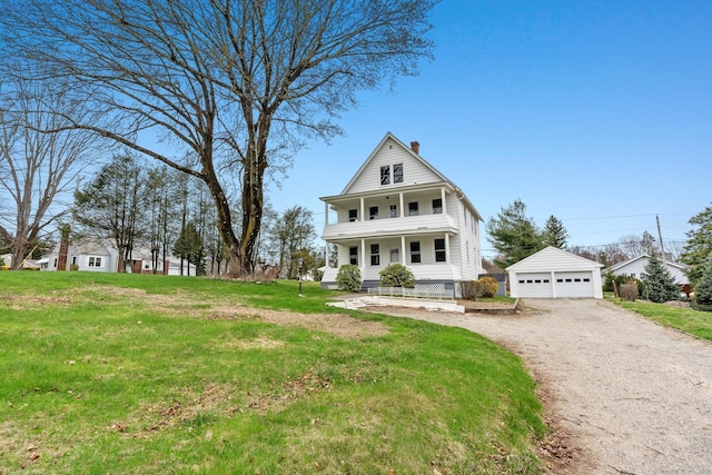view of front of house featuring a front yard, a detached garage, covered porch, a chimney, and an outdoor structure