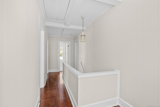 corridor featuring crown molding, beamed ceiling, attic access, dark wood-type flooring, and coffered ceiling