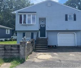 278 Wall St, Waterbury, CT 06704 - bi-level home featuring entry steps, an attached garage, and driveway