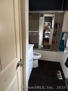 278 Wall St, Waterbury, CT 06704 - bathroom featuring toilet, vanity, tile patterned flooring, and a shower