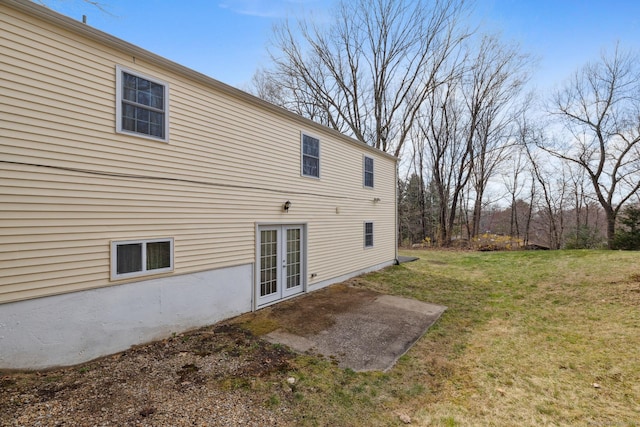 back of house featuring a patio area, french doors, and a yard