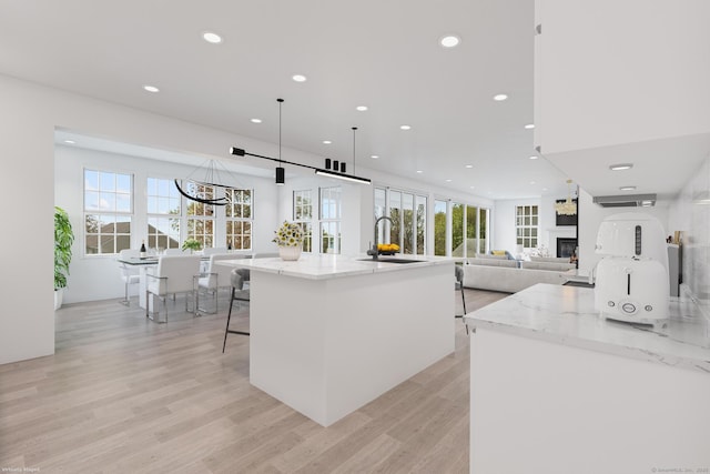 47 Lucey Ave, West Haven, CT 06516 - kitchen with recessed lighting, light stone counters, a healthy amount of sunlight, and a sink