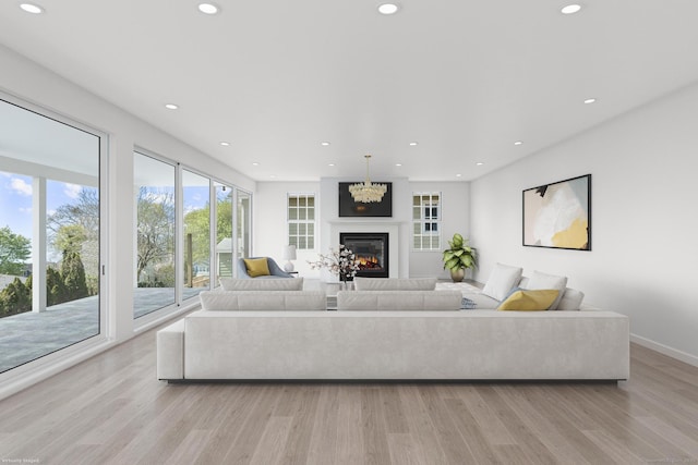 47 Lucey Ave, West Haven, CT 06516 - living room featuring an inviting chandelier, a glass covered fireplace, light wood-style flooring, recessed lighting, and baseboards