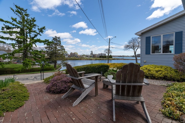 deck featuring a water view and a patio area