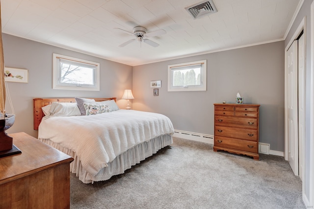 carpeted bedroom with crown molding, multiple windows, baseboard heating, and visible vents