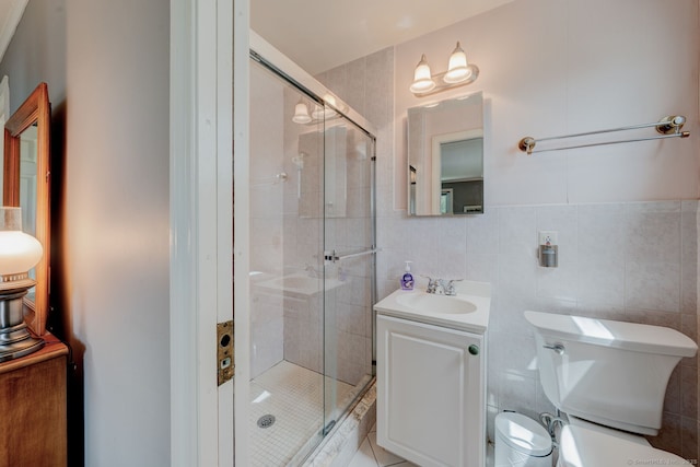 full bathroom with vanity, toilet, tile walls, and a stall shower