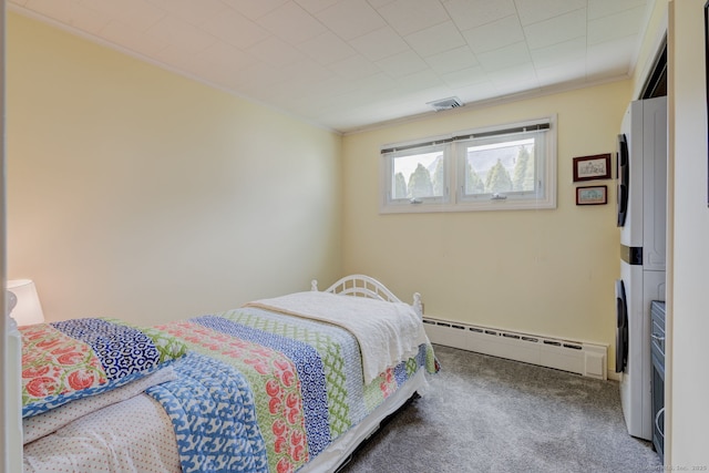 bedroom featuring crown molding, visible vents, stacked washer / dryer, a baseboard radiator, and carpet