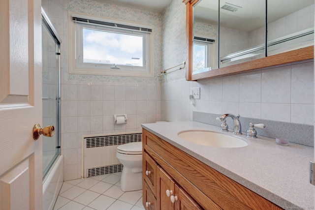 bathroom featuring visible vents, tile patterned floors, vanity, toilet, and radiator heating unit