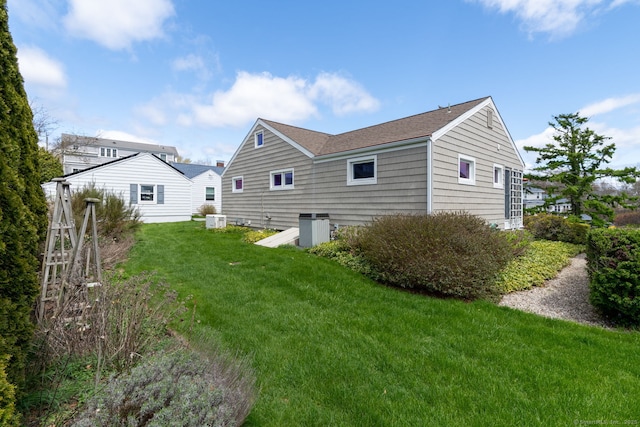 rear view of property featuring a yard