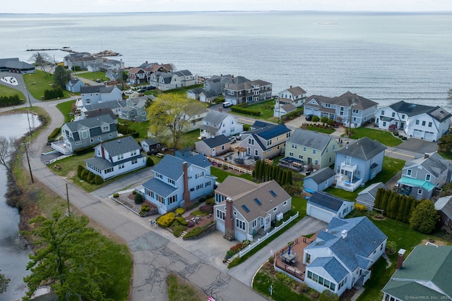 drone / aerial view featuring a water view and a residential view