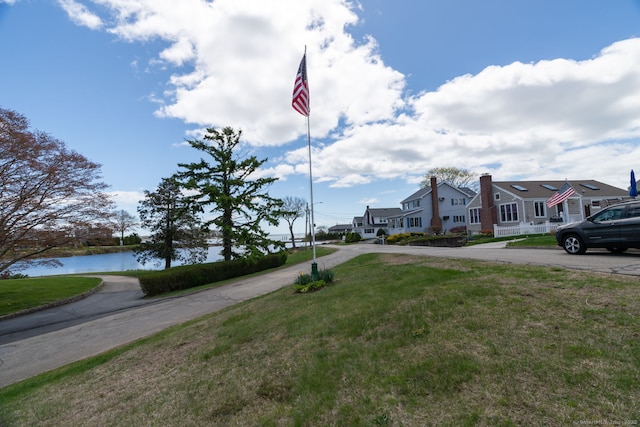 view of street with a residential view and a water view