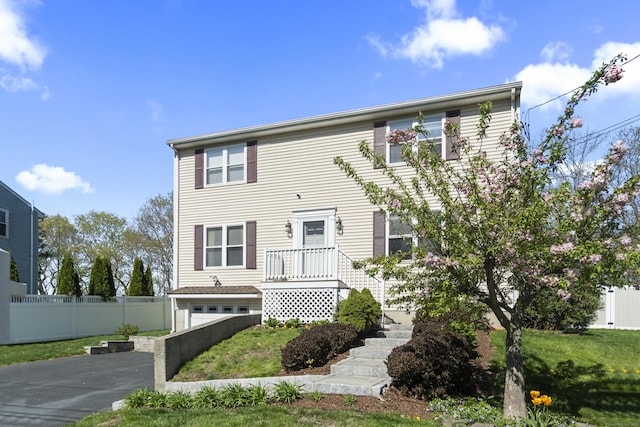 5 Ridge Ln, Shelton, CT 06484 - view of front of house featuring fence, an attached garage, driveway, and a front lawn