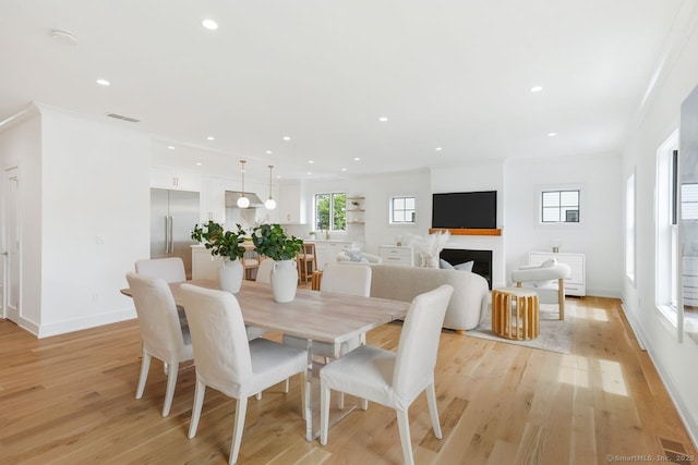 345 Reef Rd Unit B6, Fairfield, CT 06824 - dining area featuring light wood-type flooring, recessed lighting, and a fireplace