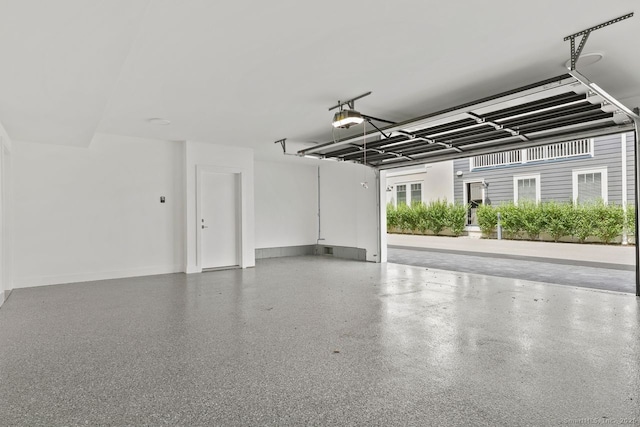 345 Reef Rd Unit B6, Fairfield, CT 06824 - garage with baseboards and a garage door opener