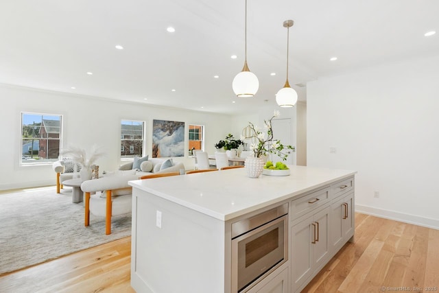 345 Reef Rd Unit B6, Fairfield, CT 06824 - kitchen with light wood finished floors, a center island, decorative light fixtures, recessed lighting, and stainless steel microwave