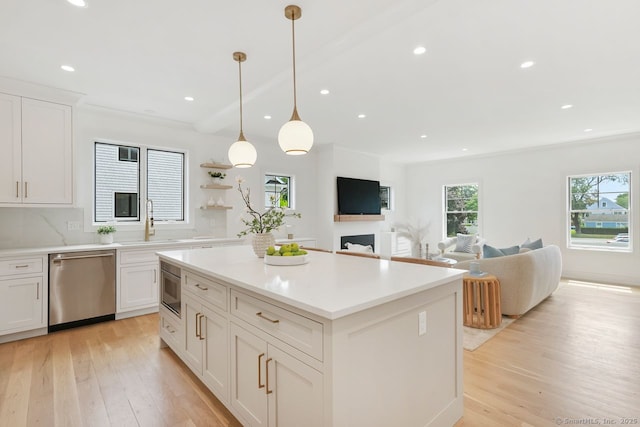 345 Reef Rd Unit B6, Fairfield, CT 06824 - kitchen featuring light wood-style flooring, dishwasher, a center island, white cabinetry, and recessed lighting