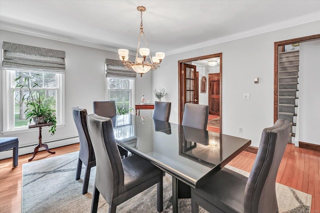 70 Cali Dr, Shelton, CT 06484 - dining space featuring a chandelier, crown molding, light wood finished floors, and baseboard heating