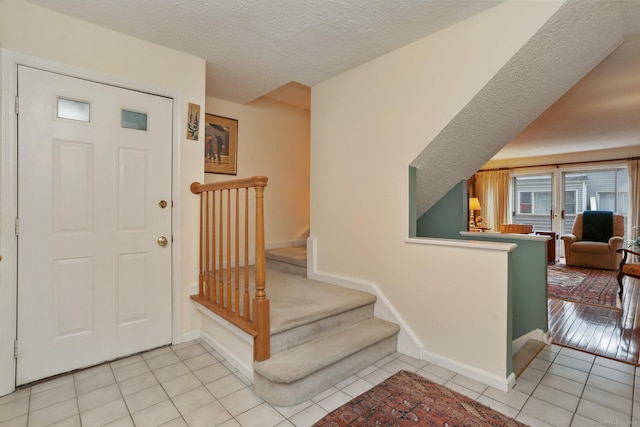37 Wilton Crst, Wilton, CT 06897 - entrance foyer featuring light tile patterned floors, a textured ceiling, and baseboards
