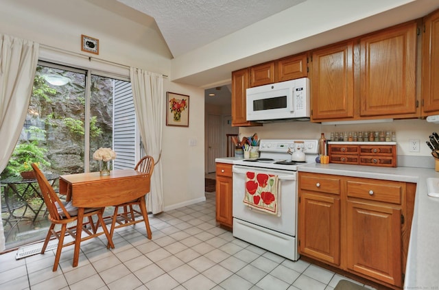 37 Wilton Crst, Wilton, CT 06897 - kitchen with white appliances, light countertops, vaulted ceiling, a textured ceiling, and brown cabinetry