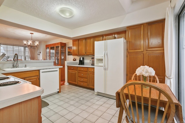 37 Wilton Crst, Wilton, CT 06897 - kitchen with white appliances, a sink, light countertops, a textured ceiling, and a chandelier