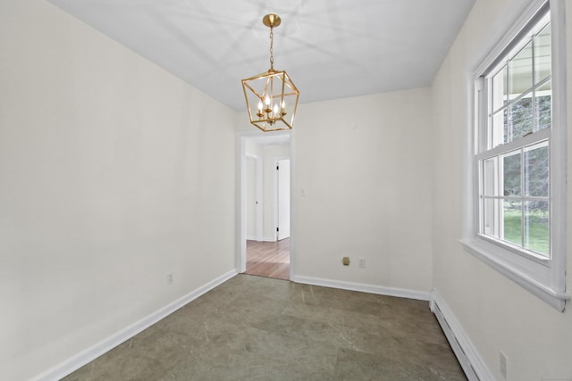 spare room featuring baseboard heating, baseboards, and a notable chandelier