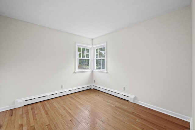 empty room featuring wood finished floors and baseboards