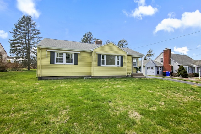 bungalow-style house with a chimney and a front yard
