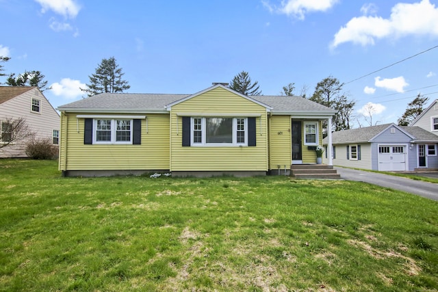 bungalow-style home with a front lawn