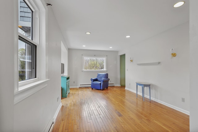 sitting room with baseboards, a baseboard radiator, recessed lighting, and light wood-style flooring