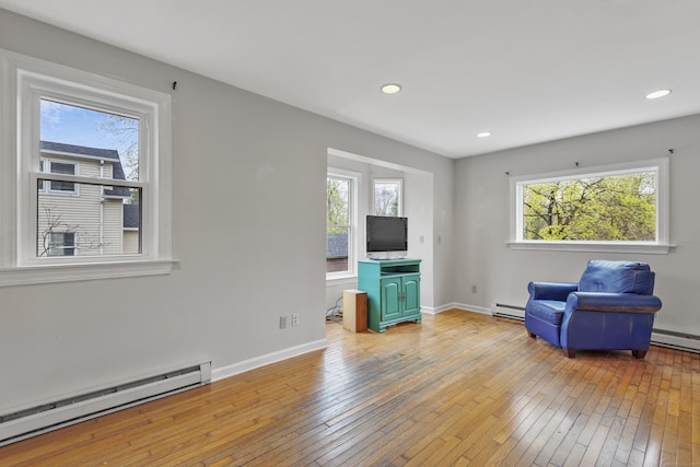unfurnished room featuring recessed lighting, baseboards, baseboard heating, and hardwood / wood-style flooring