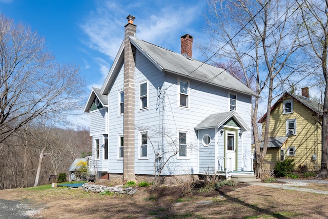 view of front facade with a chimney