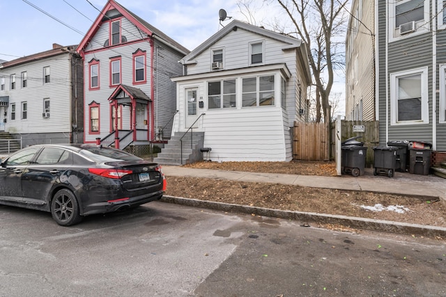 view of front of home with entry steps and fence