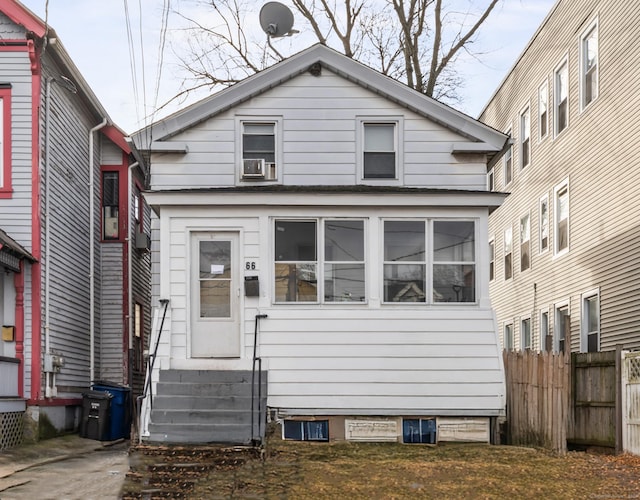 view of front of home with entry steps and fence