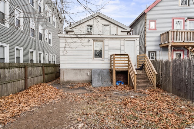 rear view of property with fence