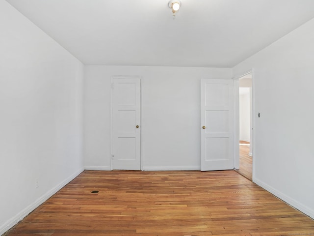 unfurnished room featuring light wood-style floors and baseboards