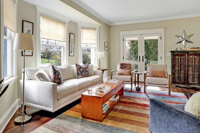living room featuring baseboards, ornamental molding, french doors, and wood finished floors