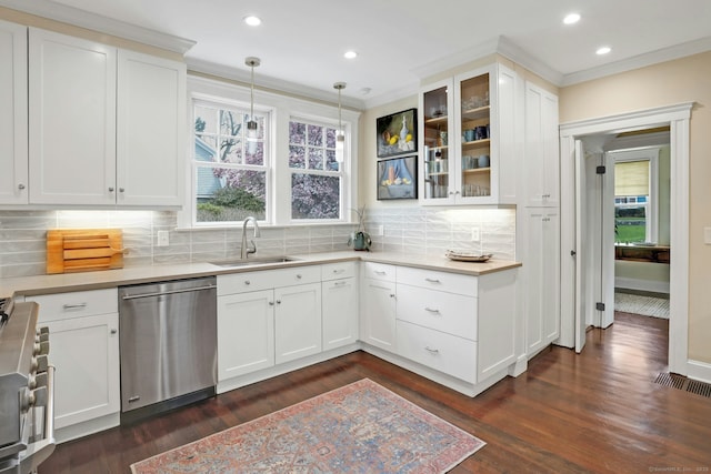 kitchen featuring tasteful backsplash, a healthy amount of sunlight, appliances with stainless steel finishes, and a sink