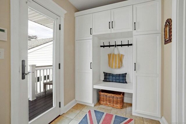 mudroom featuring baseboards and light tile patterned floors