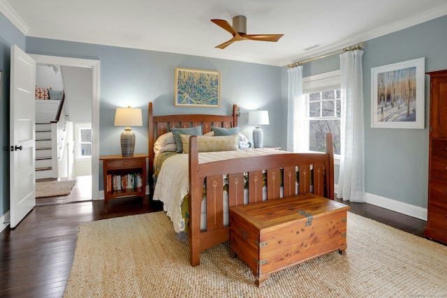 bedroom with wood finished floors, baseboards, and ornamental molding