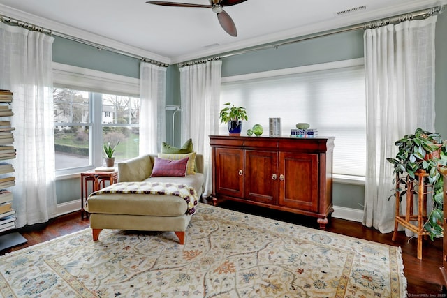 sitting room with dark wood finished floors, visible vents, baseboards, and ceiling fan