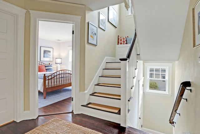stairway with baseboards and wood finished floors