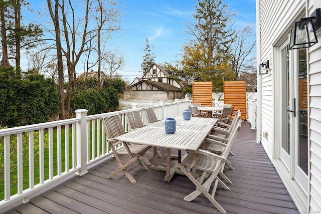 wooden terrace with outdoor dining space