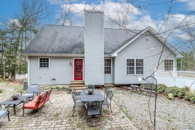 back of property featuring a patio, roof with shingles, a chimney, entry steps, and fence