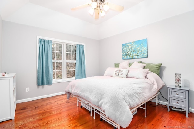 bedroom featuring baseboards, a ceiling fan, and wood finished floors